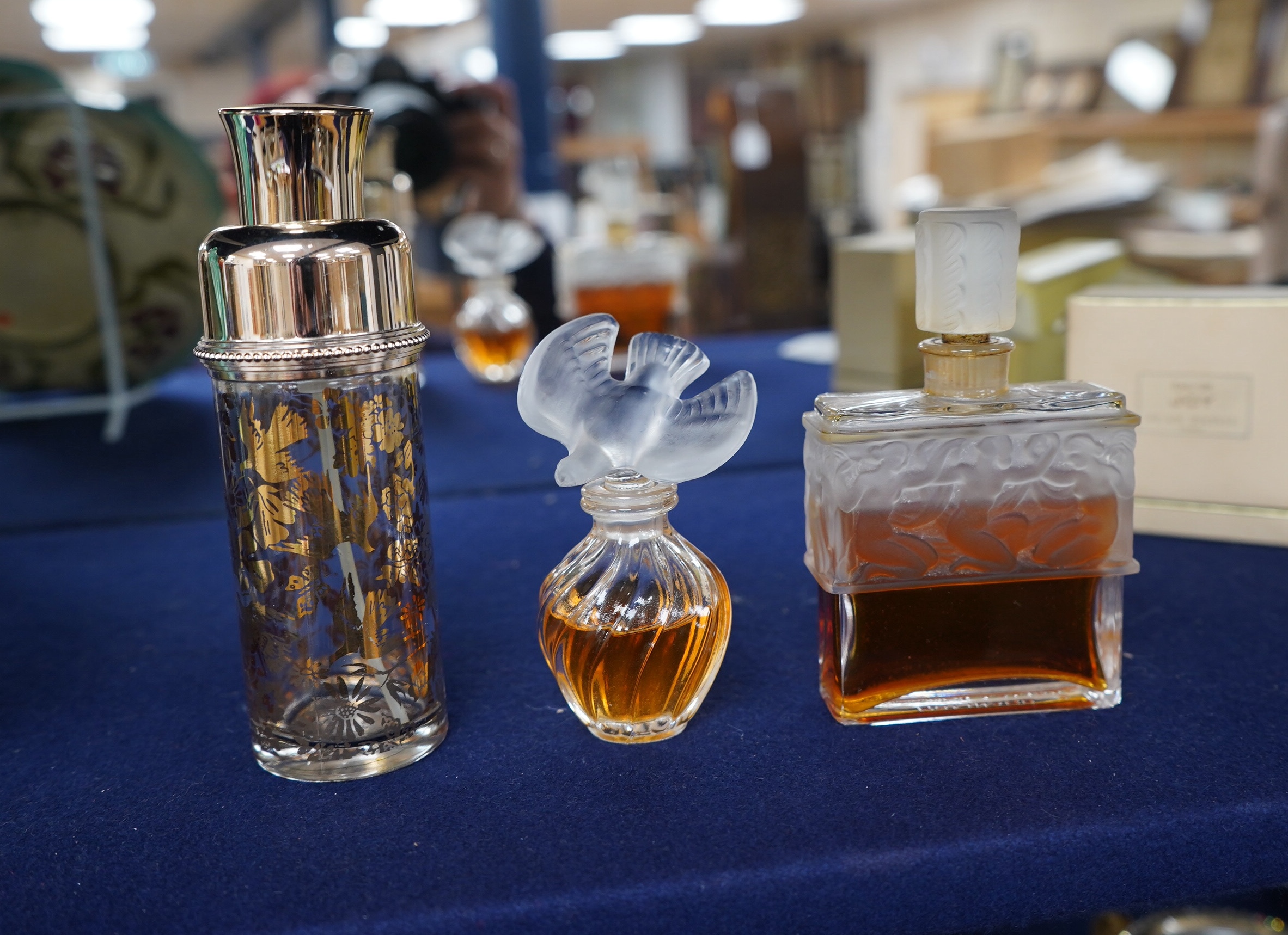 Three Lalique perfume bottles and atomisers, together with two others, tallest 14cm. Condition - fair.